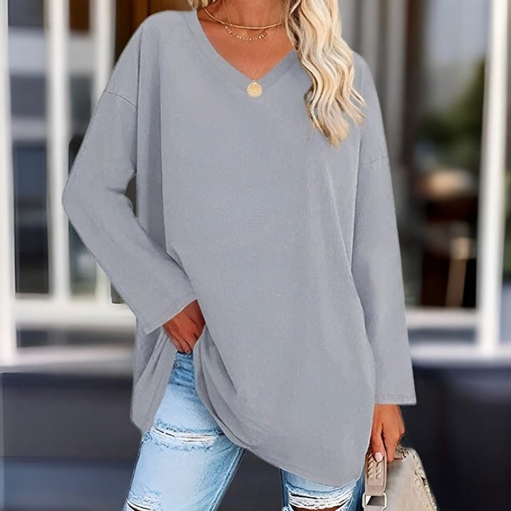 Neatly folded women's relaxed fit V-neck shirt, ready for versatile everyday comfort & travel.