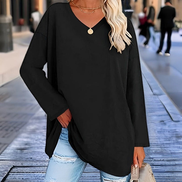 Women's relaxed V-neck comfort shirt worn in a relaxed setting, perfect for everyday casual fashion.