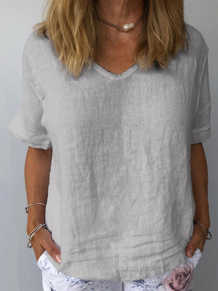 Minimalist women's V-neck short sleeve blouse, relaxed fit for everyday wear. Casual and loose summer top.
