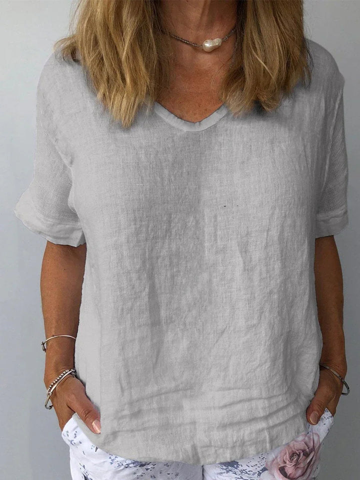 Minimalist women's V-neck short sleeve blouse, relaxed fit for everyday wear. Casual and loose summer top.