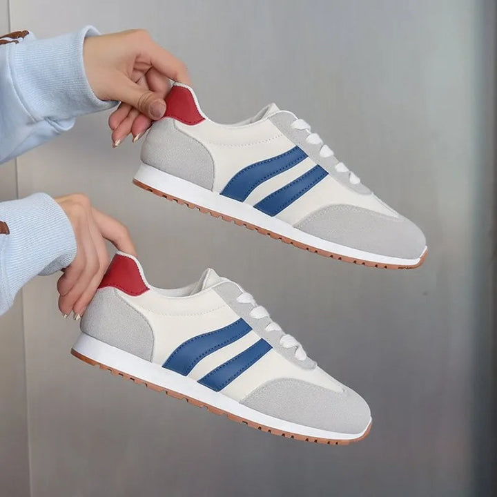 Bold retro colorblock women's sneakers with classic stripe accents & white laces. Chic and comfy casual footwear.