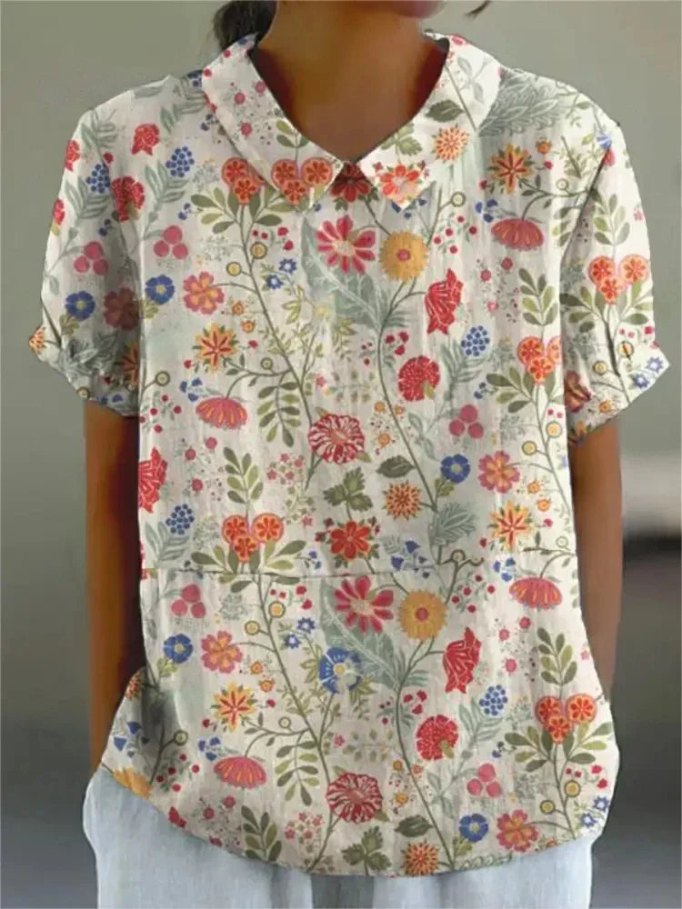 Detail of retro floral embroidery on a women's short sleeve top, vintage charm, collared.