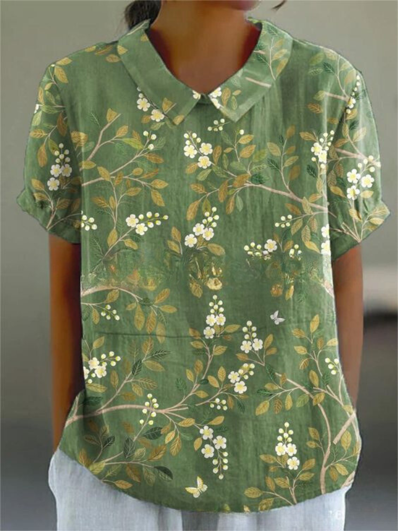 Close-up of women's embroidered floral top, retro design, comfortable short sleeve for summer.