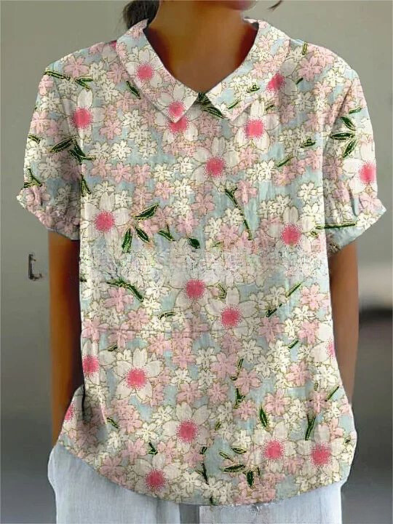 Woman wearing a breezy retro floral embroidered top, short sleeve, ideal for summer.