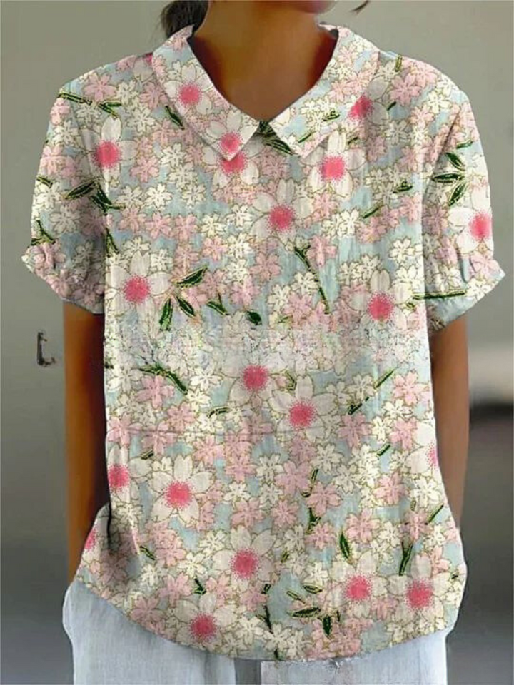 Woman wearing a breezy retro floral embroidered top, short sleeve, ideal for summer.