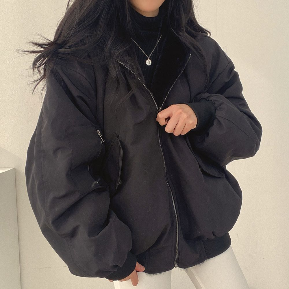 Women's reversible hooded jacket, showing patterned chic side, ideal for winter casual wear.