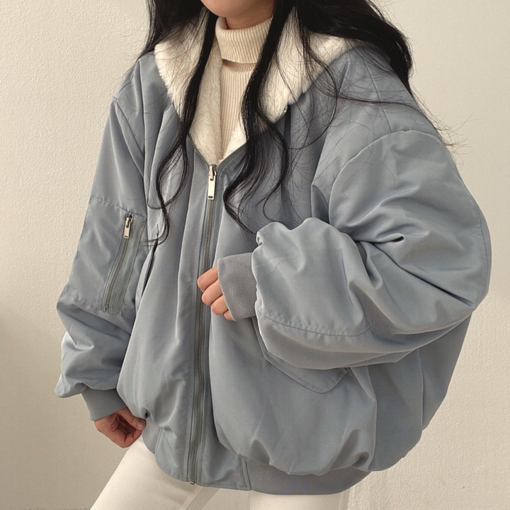 Product shot: Women's reversible hooded jacket, highlighting cozy fabric, hood, and versatile design.