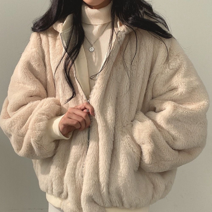 Woman models a cozy reversible hooded jacket, perfect for autumn casual wear and winter travel.