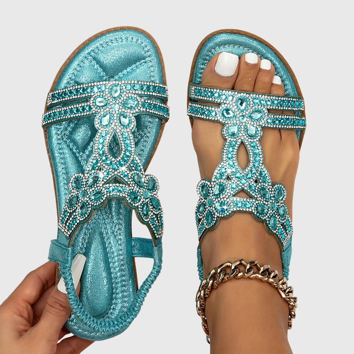 Glamorous women's flat sandals with rhinestone straps, perfect for summer.