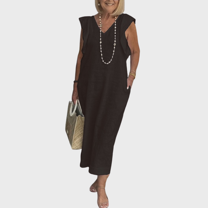 Flowy sleeveless V-neck maxi dress for women with charming ruffle shoulders and functional side pockets.