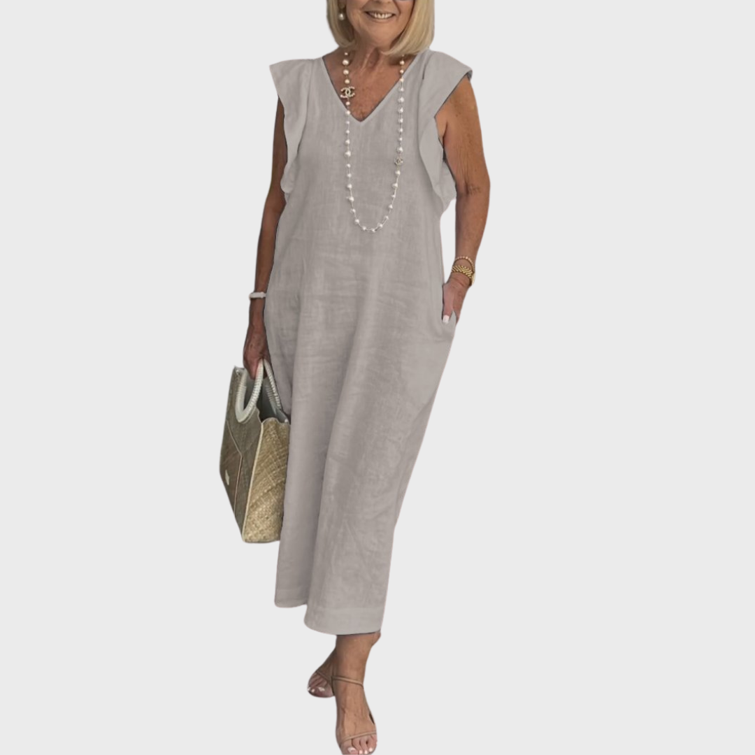 Long women's maxi dress with V-neck, fashionable ruffle shoulders & essential pockets for a stylish look.