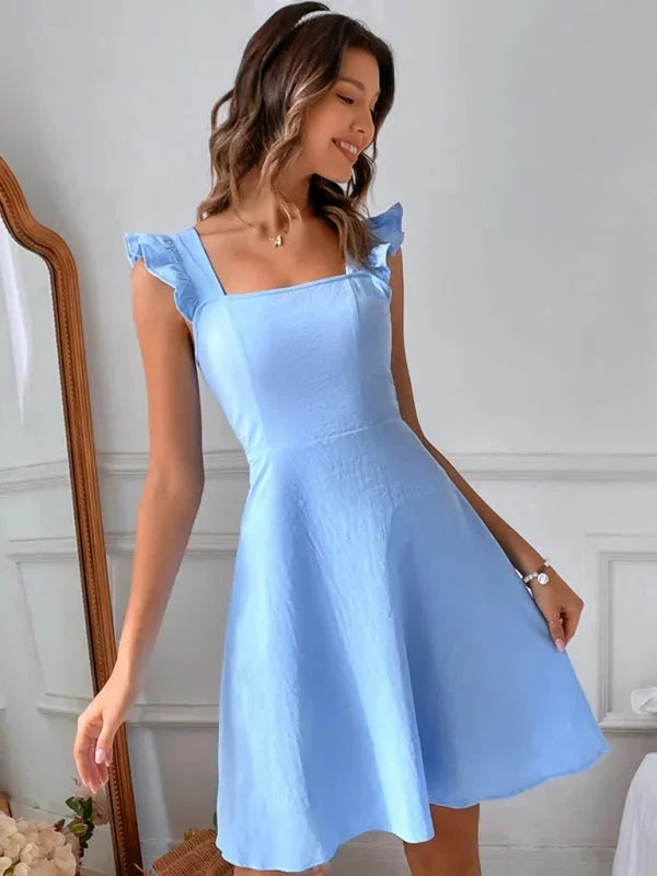 Feminine party dress: Ruffle strap A-line mini with elegant bow back detail.