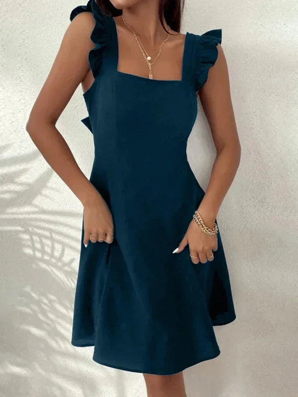 Women's elegant short A-line dress with delicate ruffle straps and bow back.