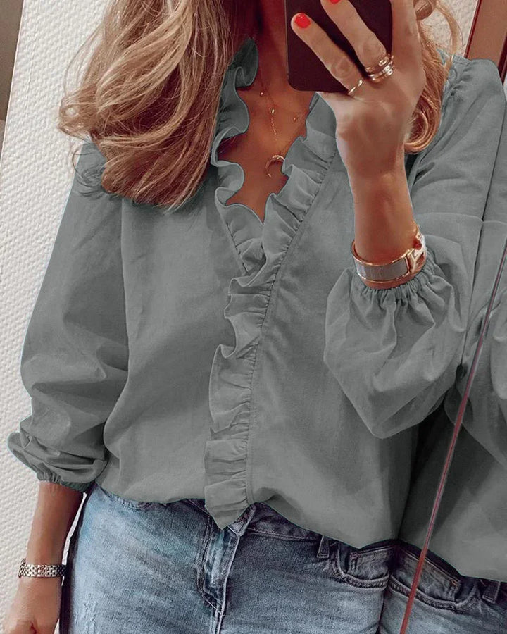 Fashionable women's long sleeve ruffle blouse featuring a flattering V-neck, perfect for casual or office attire.