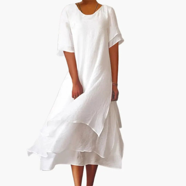 Women's sleeveless midi dress with round neck & fitted waist, perfect for elegant casual summer wear.