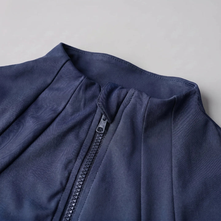 Stylish women's slim-fit sports jacket. Performance activewear with thumbholes, ideal for yoga & gym.