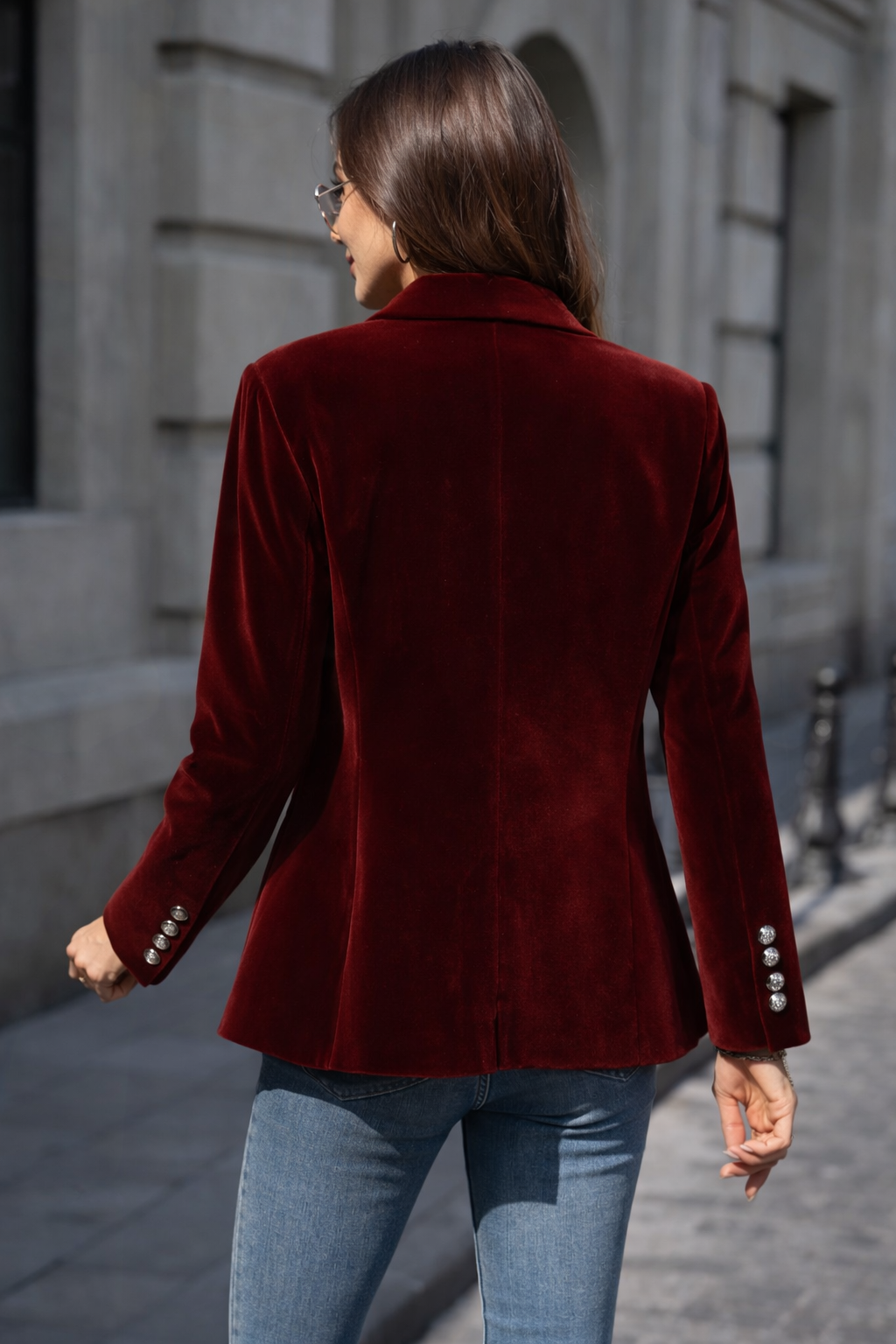 Front view of a women's black velvet blazer, gold buttons, slim fit, and elegant design.
