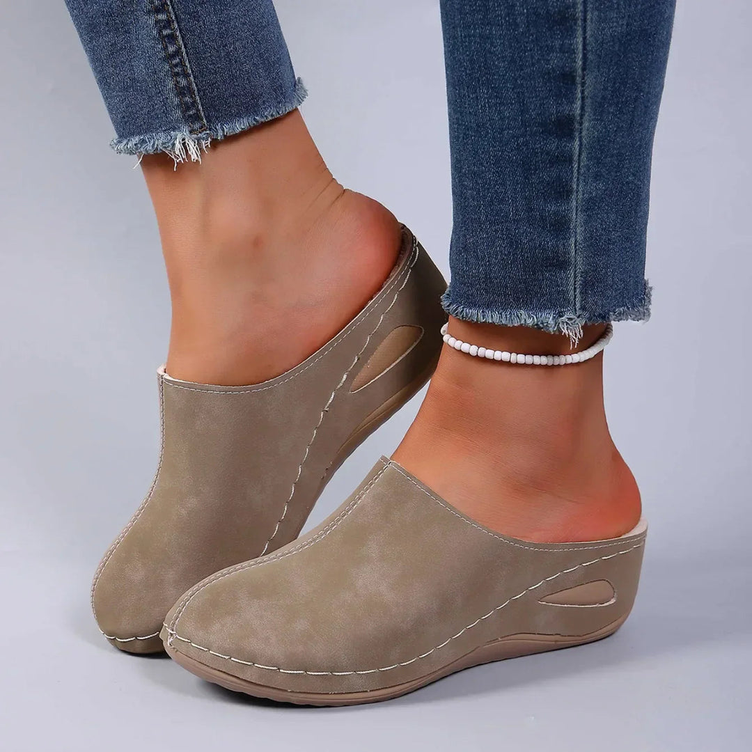 Comfortable women's slip-on clogs providing all-day support. Essential casual footwear for any activity.