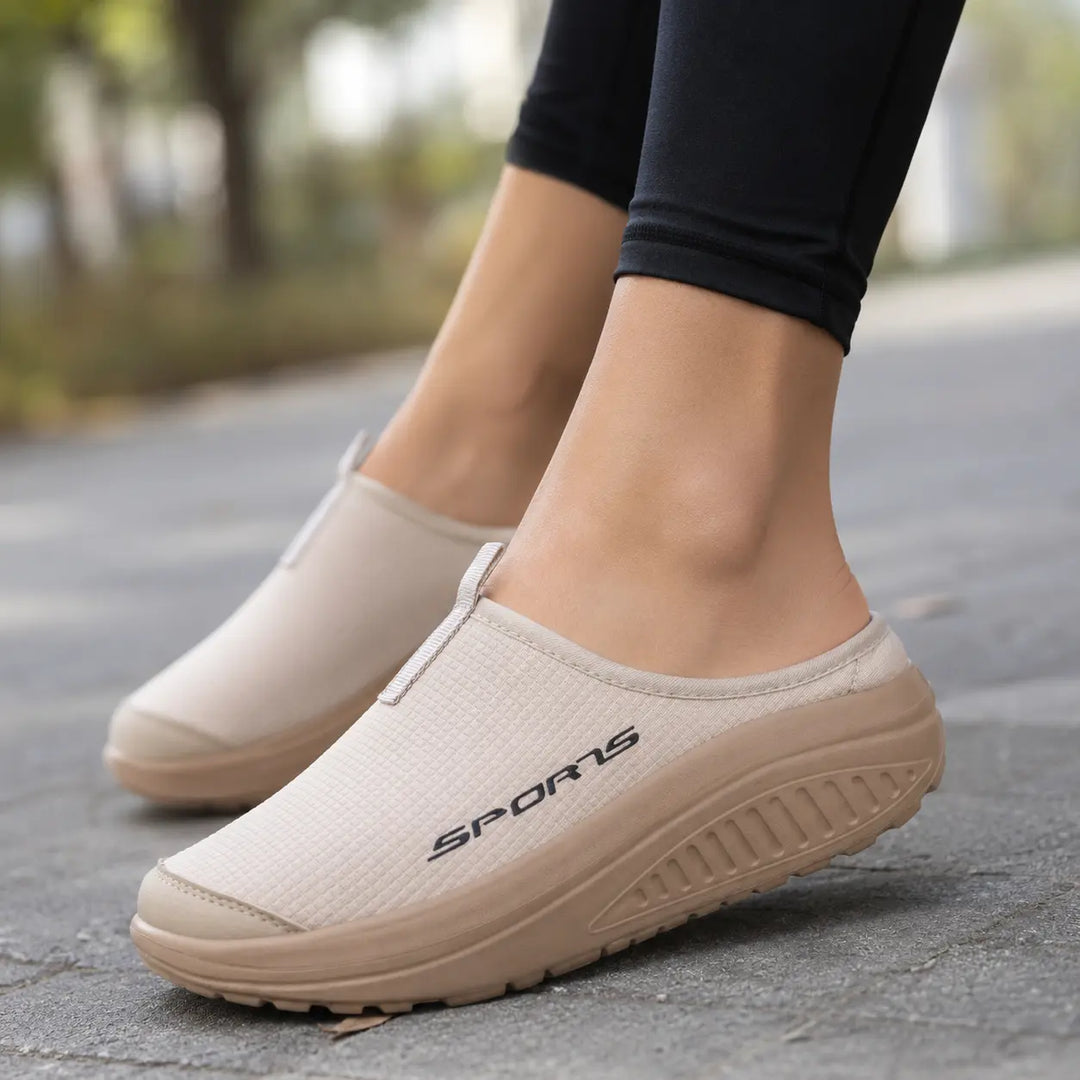 Grey women's slip-on orthopedic comfort slippers, perfect for indoor everyday use. Cushioned & supportive.