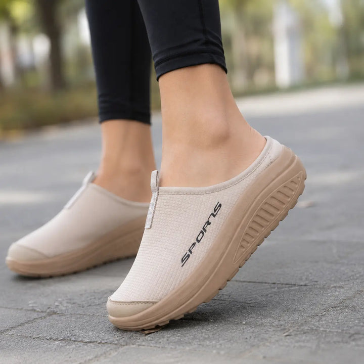 Soft women's slip-on comfort slippers, providing orthopedic arch support & plush cushioning for home relief.