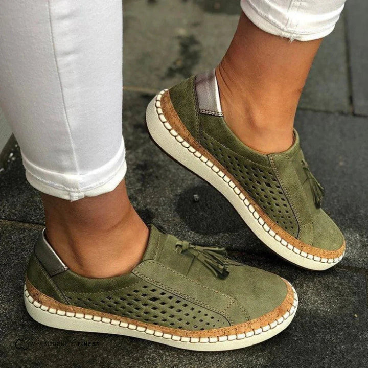 Women's slip-on perforated sneakers with tassel detail, ideal for comfortable casual everyday wear.
