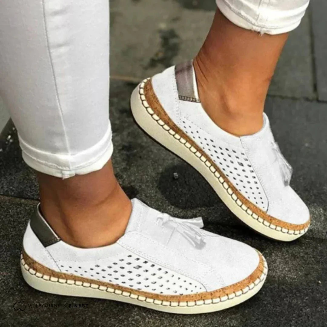 Breathable ladies' perforated slip-on sneakers with elegant tassel accents. Perfect for everyday casual comfort.