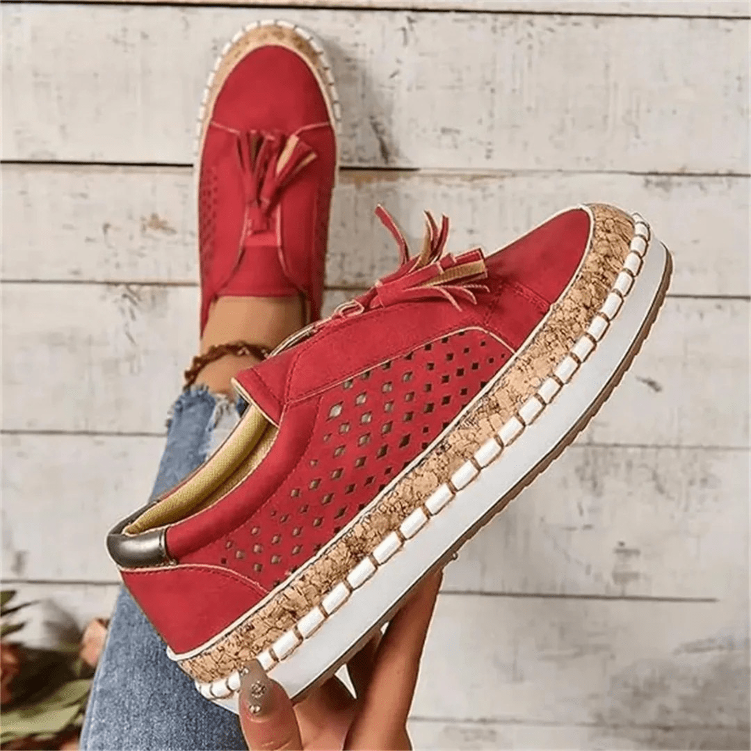 Comfortable women's slip-on sneakers, perforated for breathability, with stylish tassels for versatile casual wear.