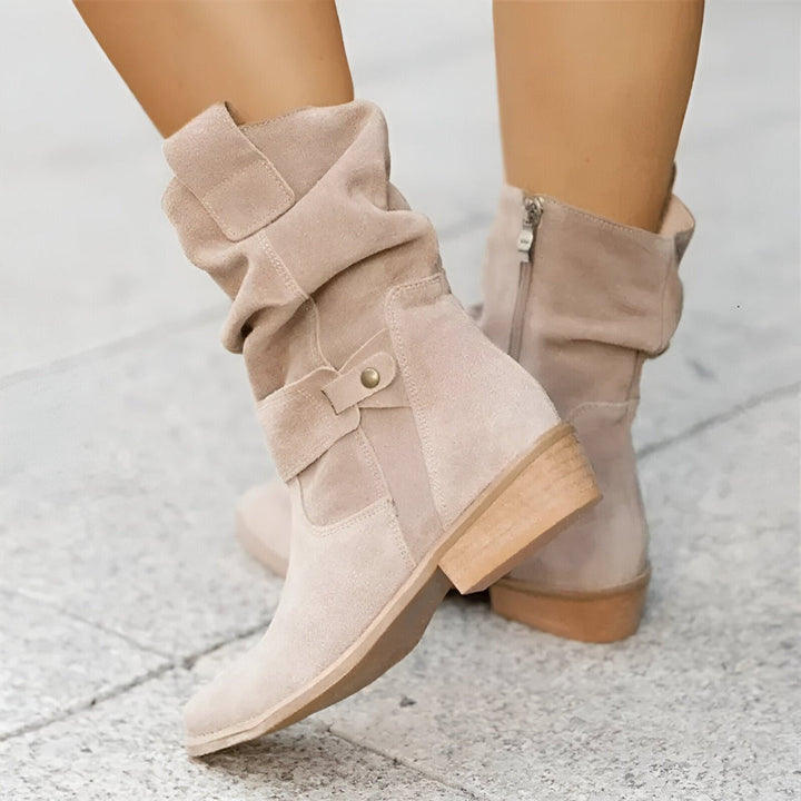 Versatile women's ankle boots, featuring a relaxed slouchy design, low heel, and decorative buckle strap.