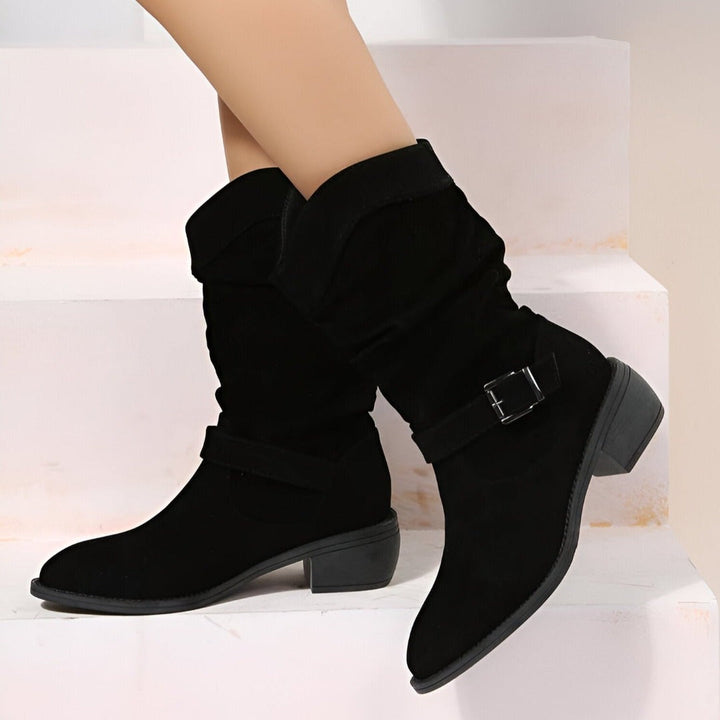 Women's fashion ankle boots, slouchy silhouette, comfortable low heel, and distinctive buckle strap detail.