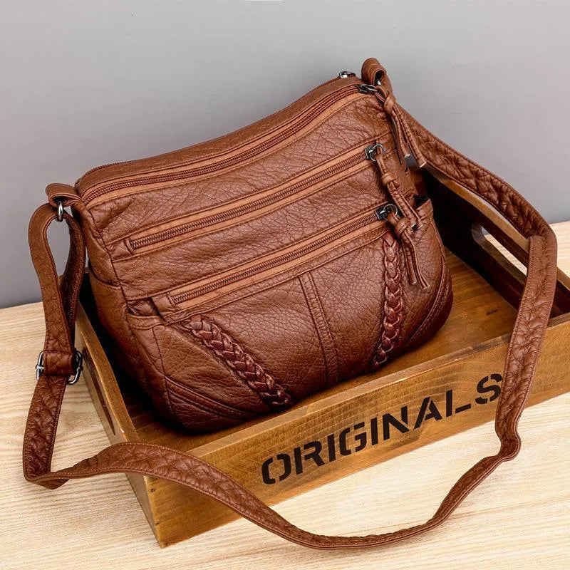 Women's soft brown leather shoulder bag, an elegant & practical everyday carry accessory. Classic versatile design.