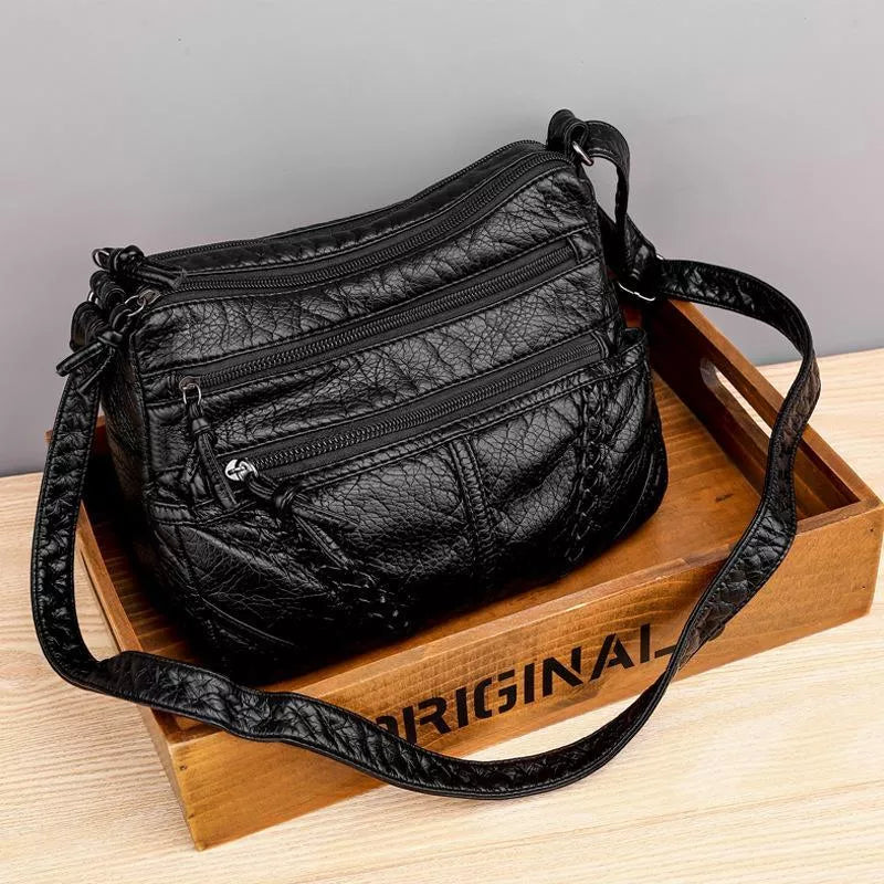 Stylish women's black soft leather shoulder bag. A practical purse with a classic design for versatile everyday fashion.