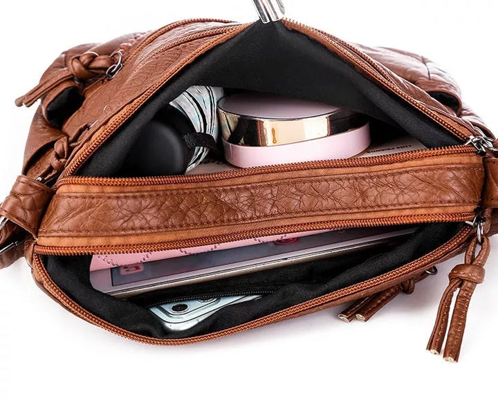 Elegant women's soft leather shoulder bag in a rich brown color. Perfect everyday carry for a stylish, practical look.