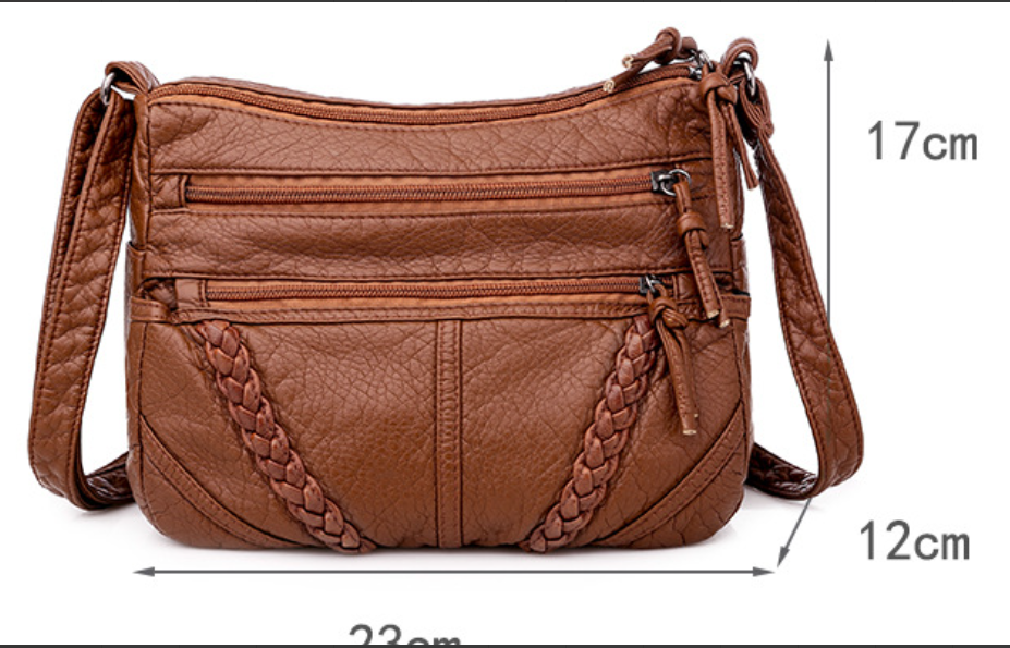 Versatile women's soft leather handbag, a sleek black shoulder bag designed for everyday elegance & practical use.