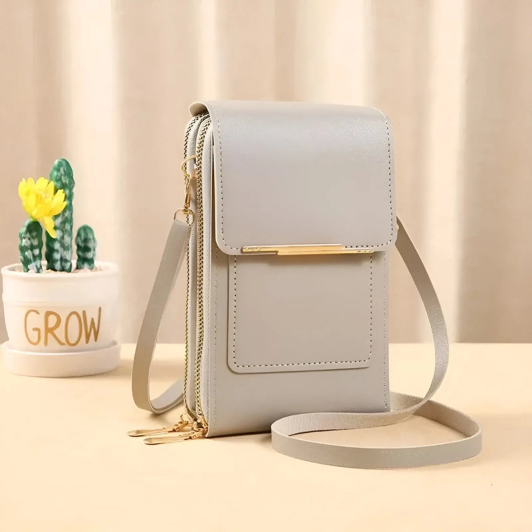 Woman carrying a soft leather anti-theft shoulder bag. Stylish & secure everyday travel handbag.