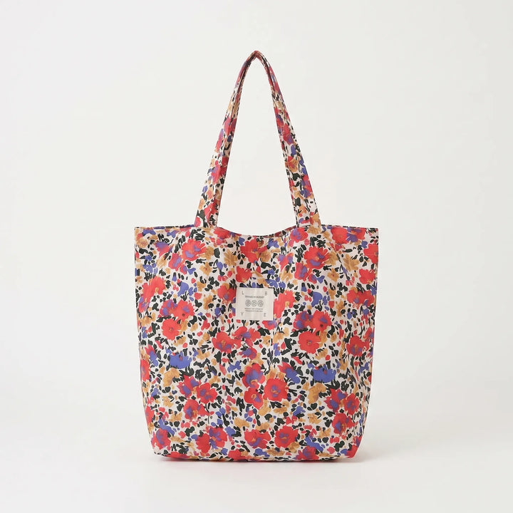 Modern women's floral print tote bag, a soft shoulder carryall with a spacious interior, perfect for any outfit.