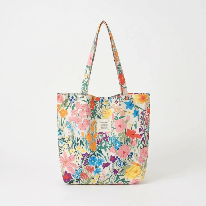 Colorful women's summer tote bag, a large soft shoulder accessory with a stylish floral print for a fresh look.