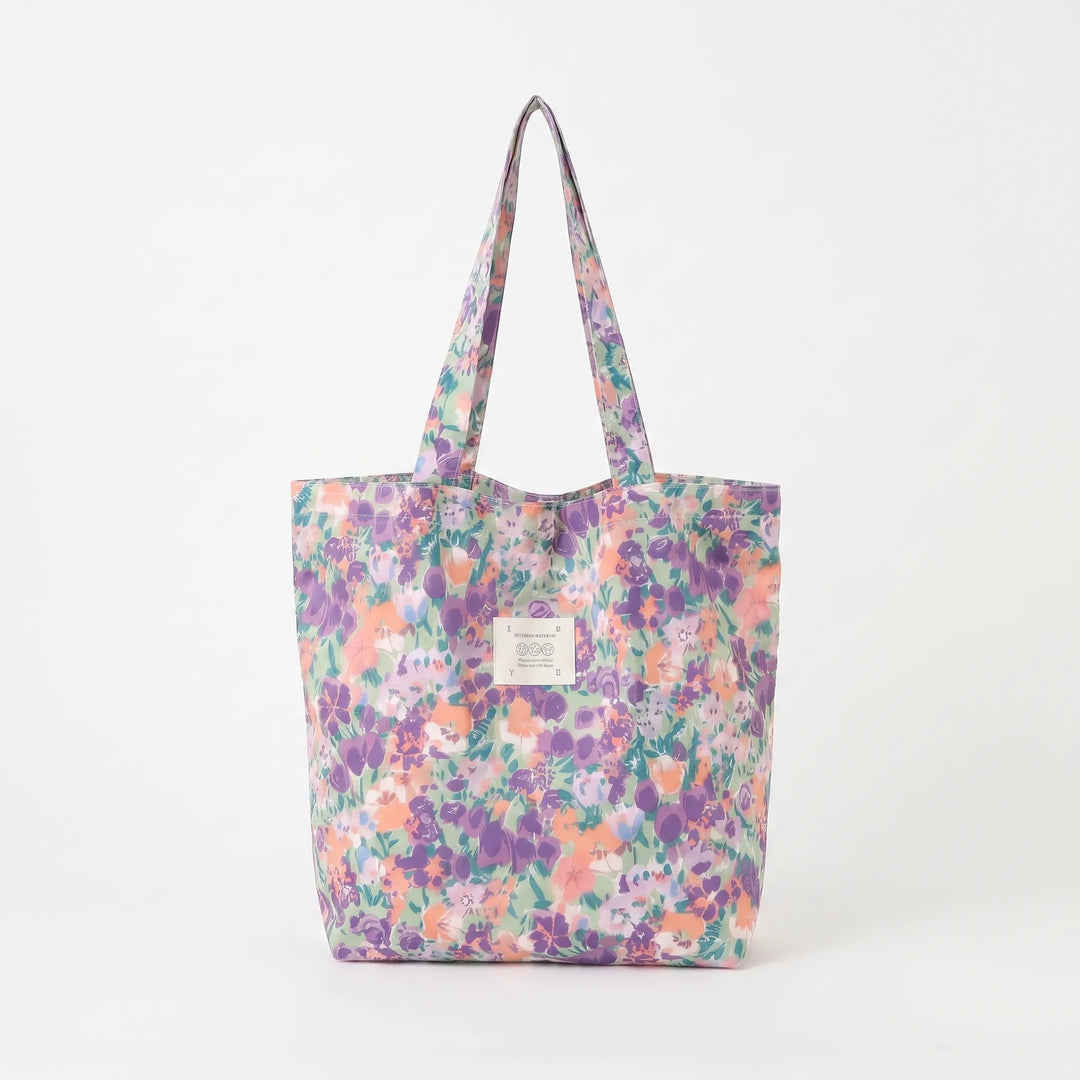 Soft shoulder women's tote bag showcasing a lovely floral print. A colorful, large fashion accessory for women.