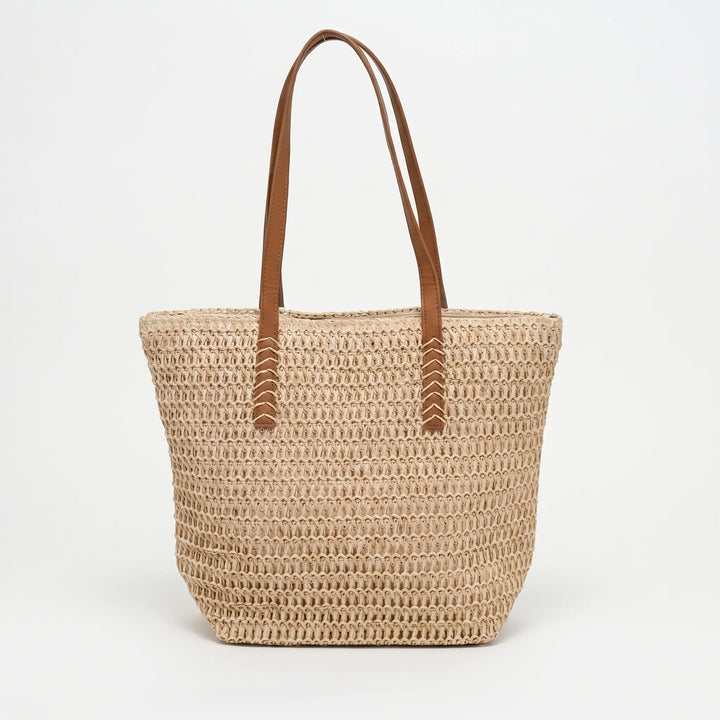 Elegant natural-tone woven tote bag for women. Spacious shoulder bag, ideal as a beach or everyday carryall.