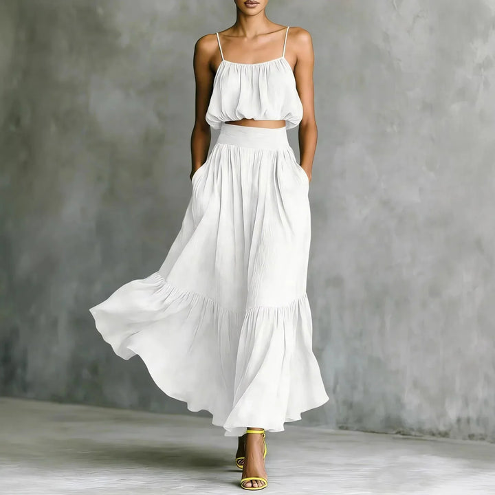 Women's summer two-piece outfit: spaghetti strap crop top & flowy ruffle maxi skirt. Great for beach holidays.