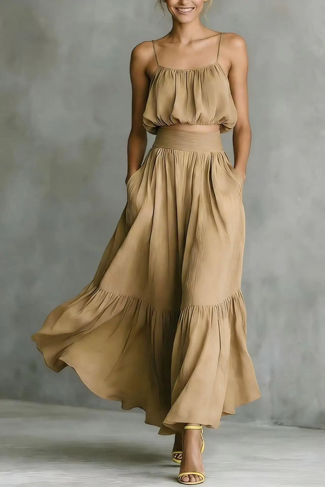 Stylish women's vacation outfit with a spaghetti strap crop top and a high-waisted ruffle maxi skirt.