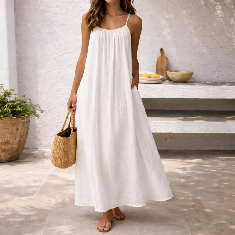 Flowy women's casual maxi dress with spaghetti straps & pockets, ideal for summer daily wear.