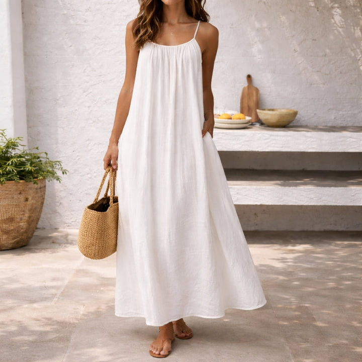 Flowy women's casual maxi dress with spaghetti straps & pockets, ideal for summer daily wear.