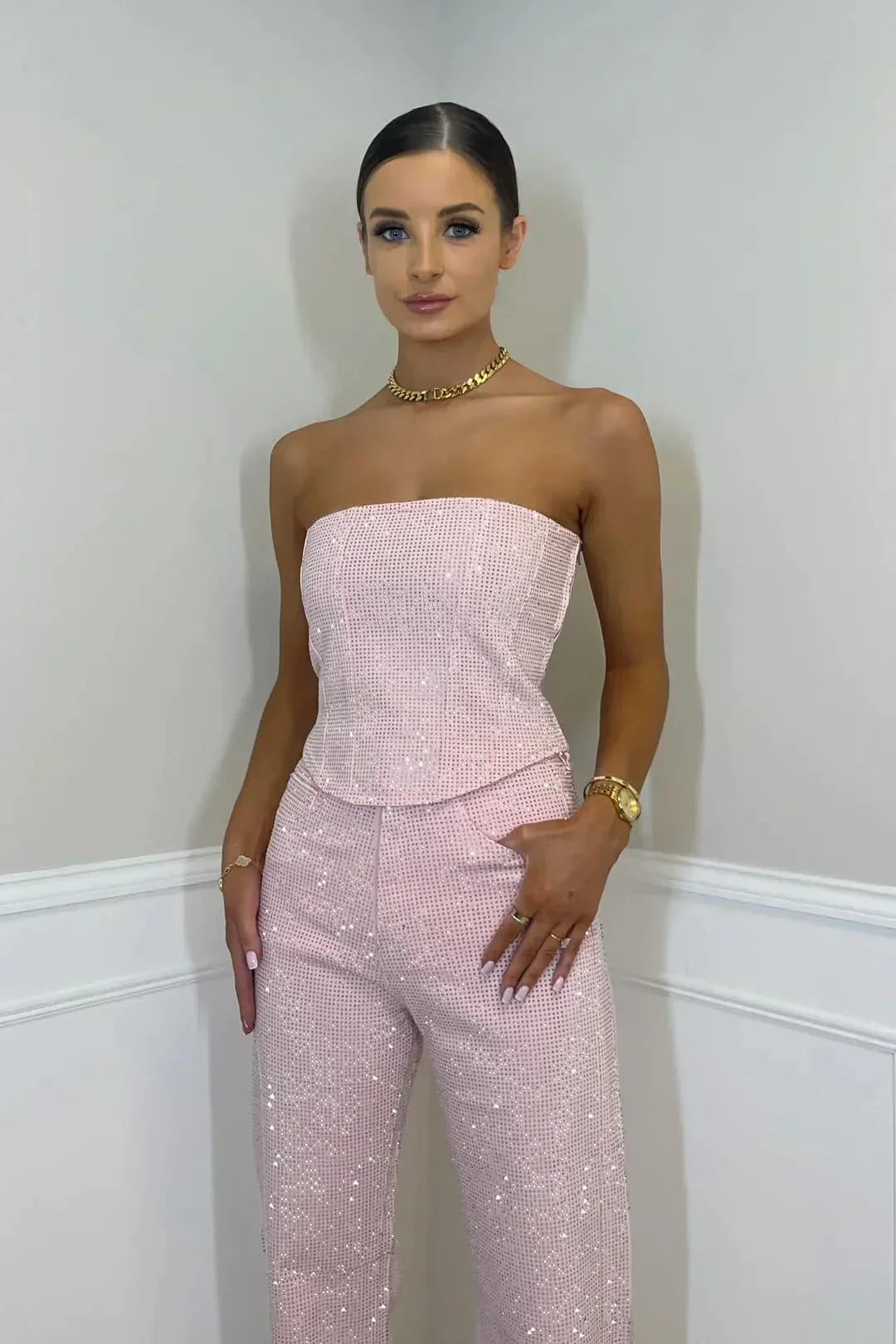 Trendy women's fashion: sparkling crop top and high-waist denim set for evening wear.