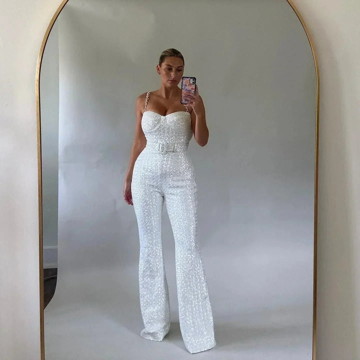 Glamorous women's strapless jumpsuit, sparkling glitter fabric with an elegant waist belt, chic party outfit.