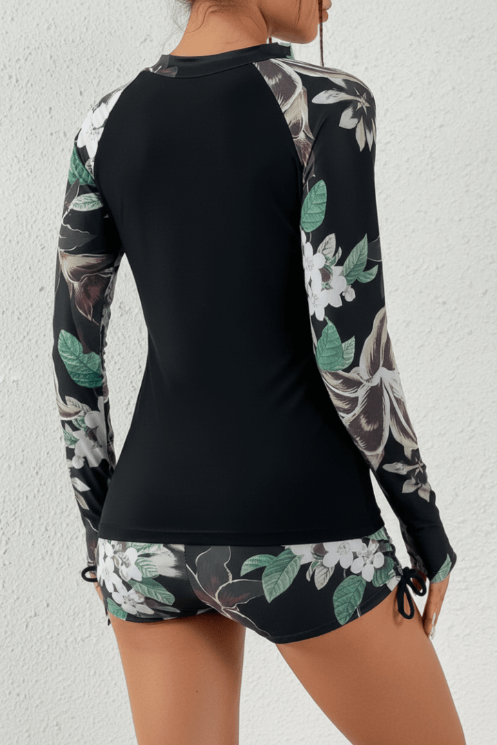 Modest tropical rashguard two-piece swimsuit for women, perfect beachwear for vacation & sun protection.