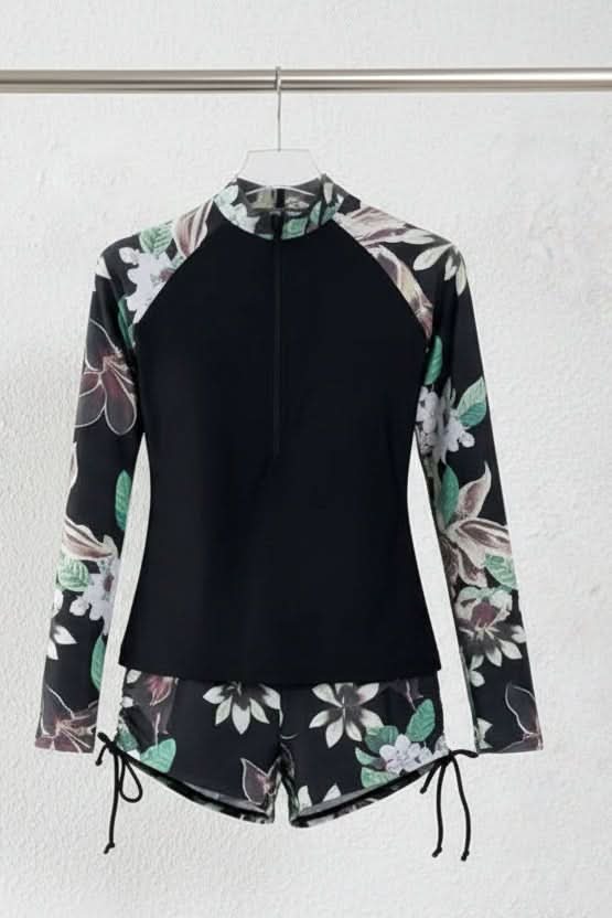 Sporty women's rashguard two-piece with tropical print, ideal for active swim, summer fashion & poolside.