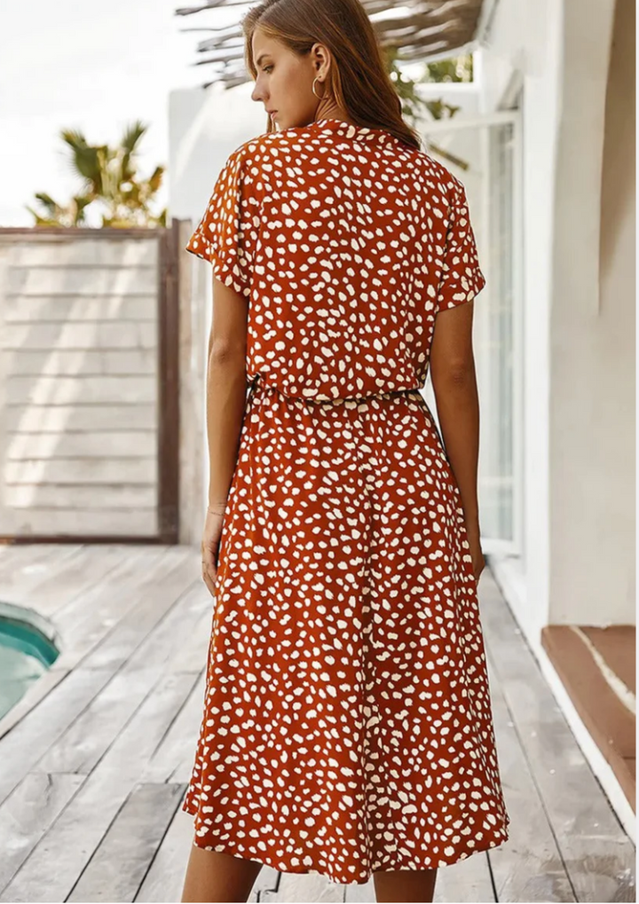 Chic women's spotted midi dress with flutter sleeves & effortless style.