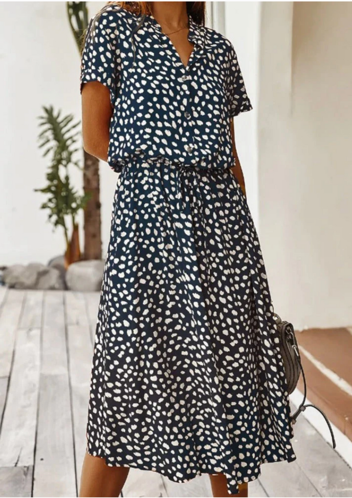Feminine spotted midi dress, V-neck, short flutter sleeves, & spring style.