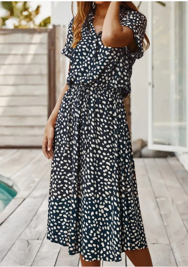 Modern women's spotted midi dress with full button-down and a flattering fit.