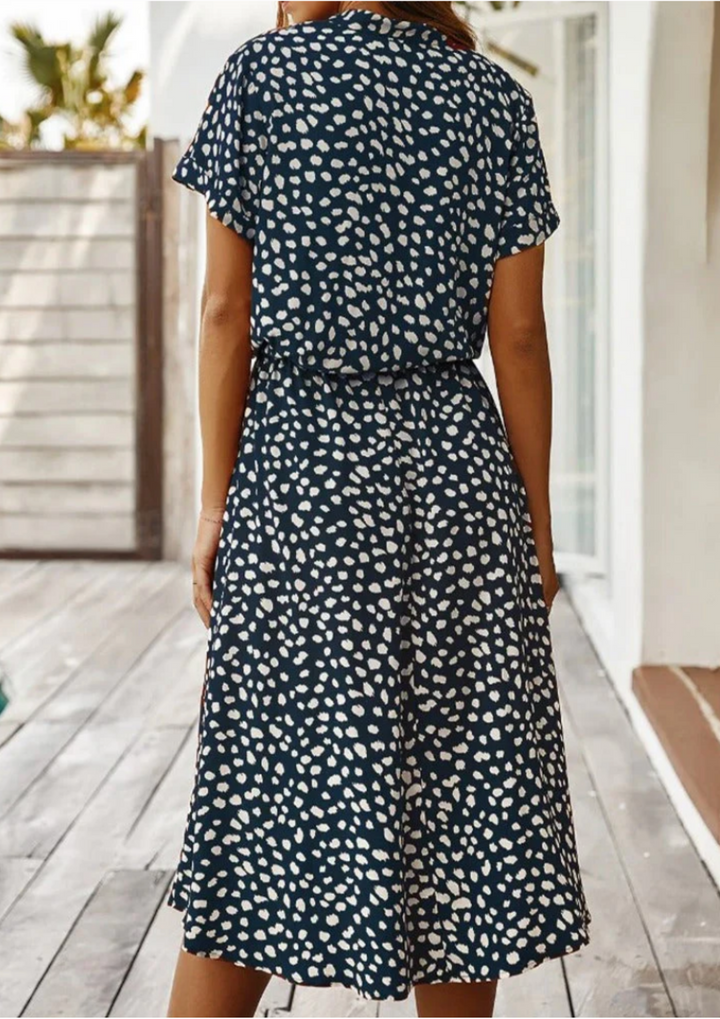 Light & airy spotted button-down midi dress, perfect for beach or city wear.